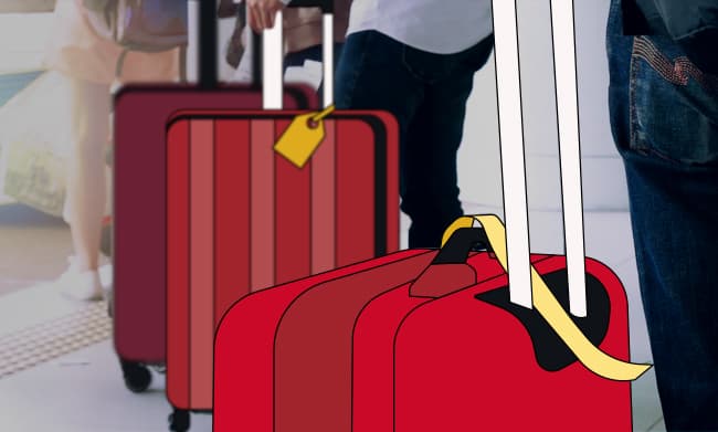 Two large red suitcase with tags on for an international flight