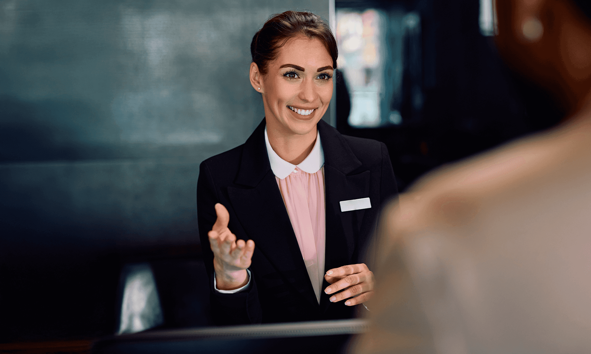 Receptionist booking a taxi for a guest on the Freenow online Web Booker