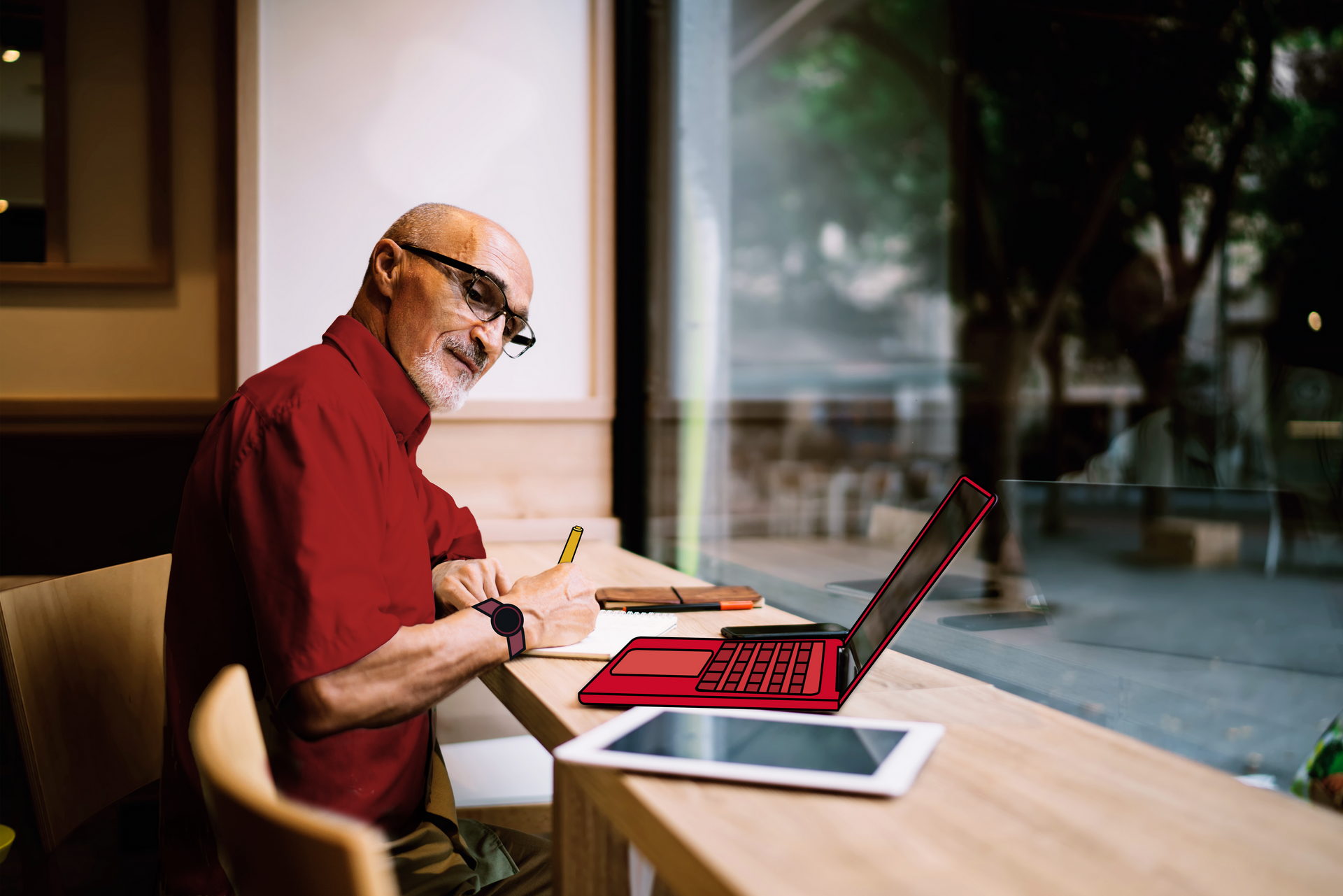Un empleado trabaja con un ordenador y una tableta en un ambiente de trabajo confortable