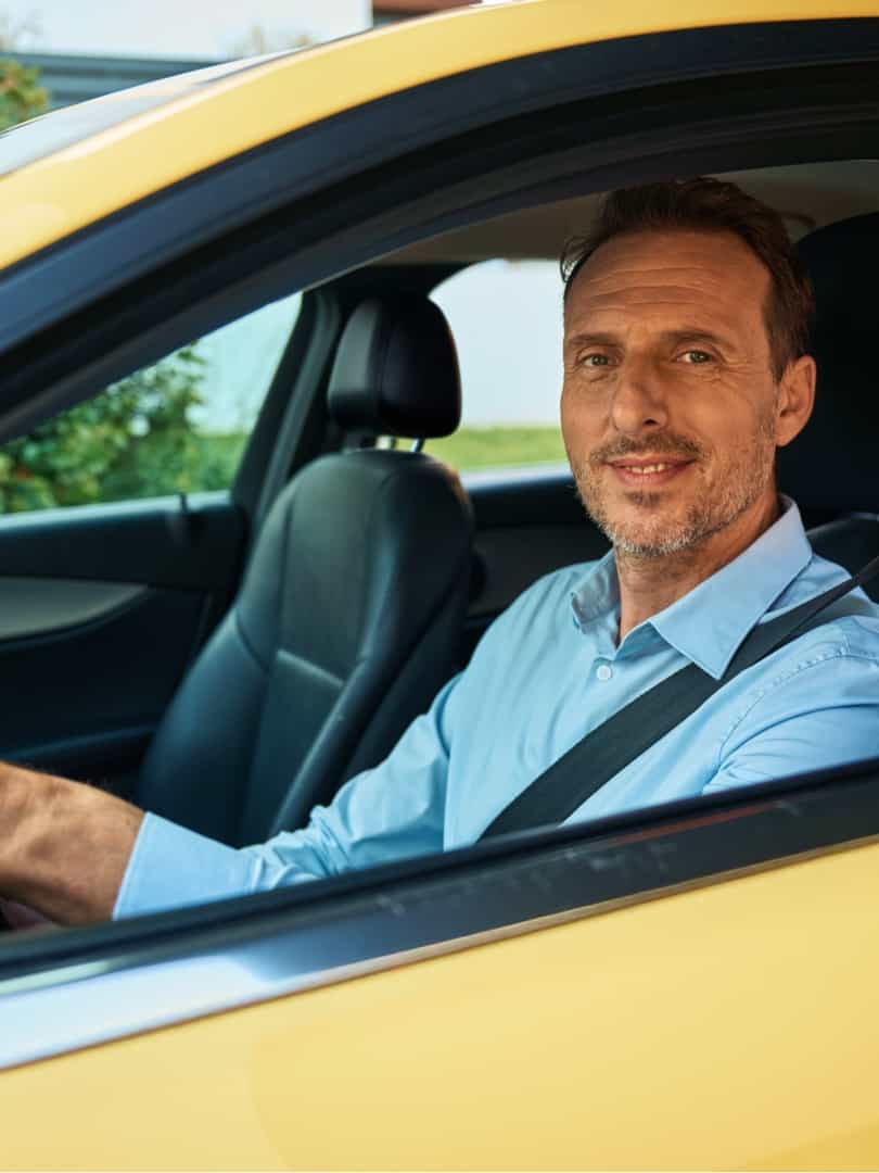 Taxi driver standing next to his car