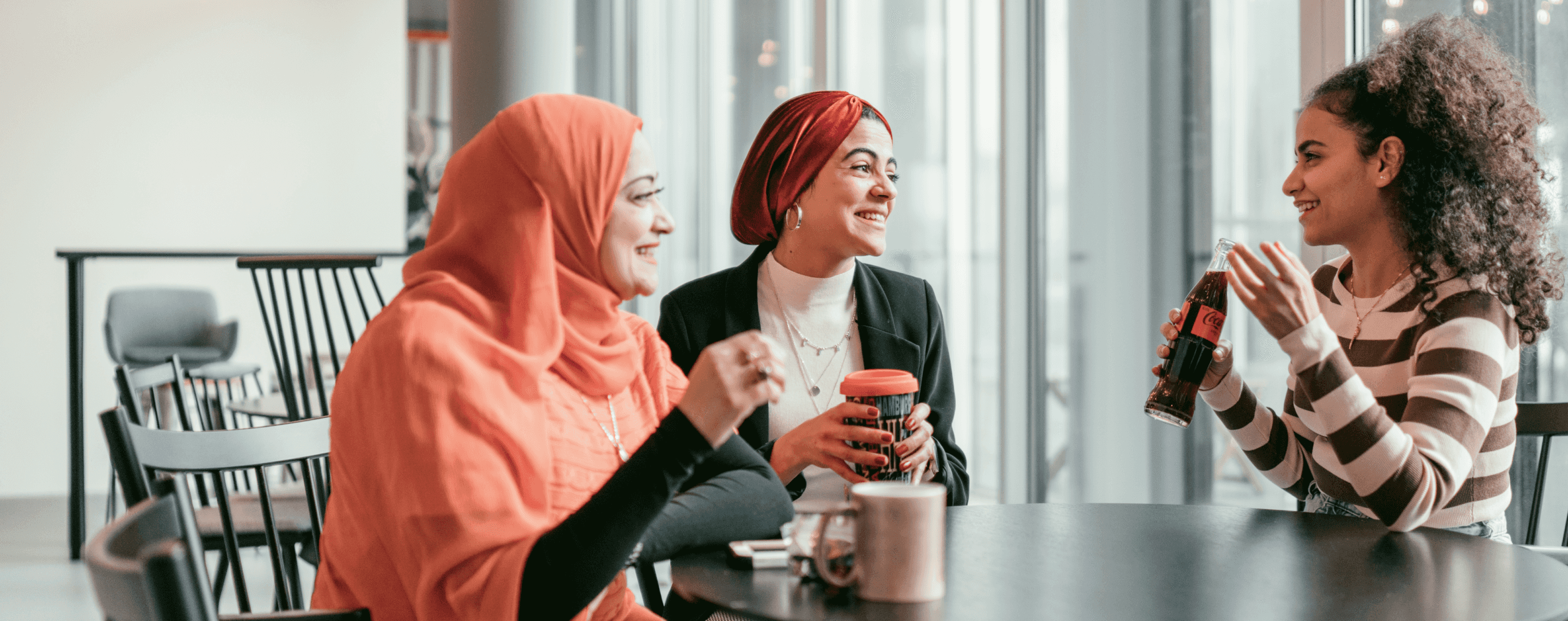 three women chatting in an office