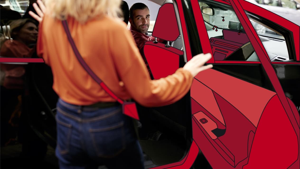 woman entering the back of a taxi